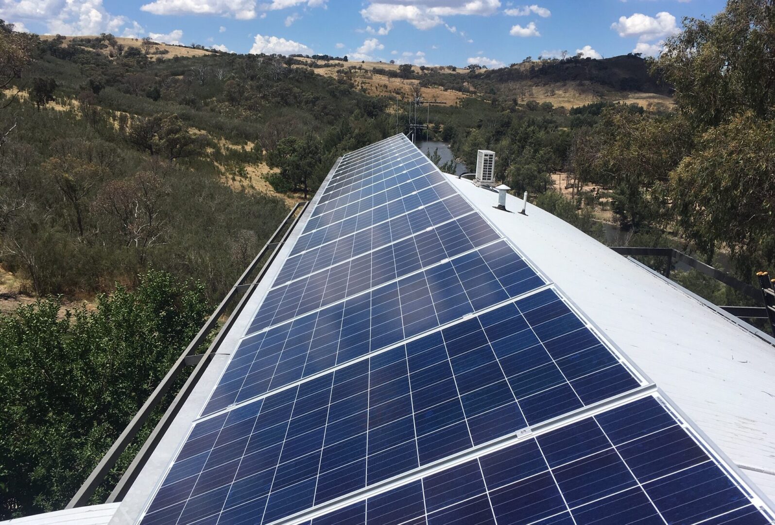 A view of the top of a building with solar panels on it.
