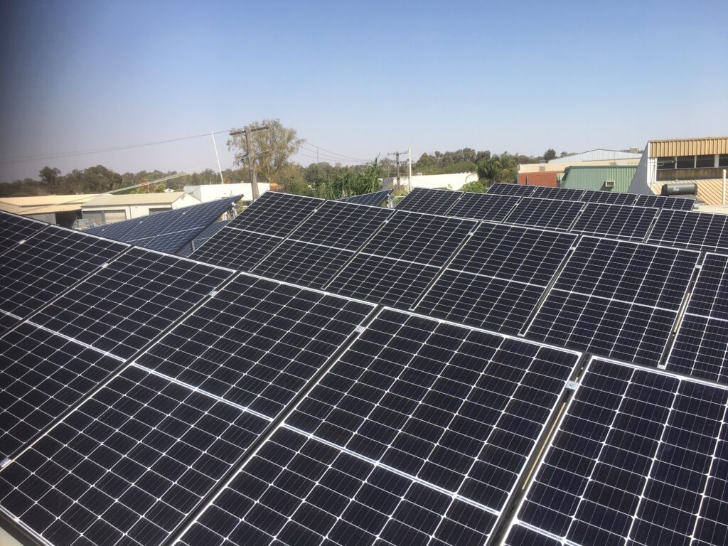 A large solar panel array on top of a building.