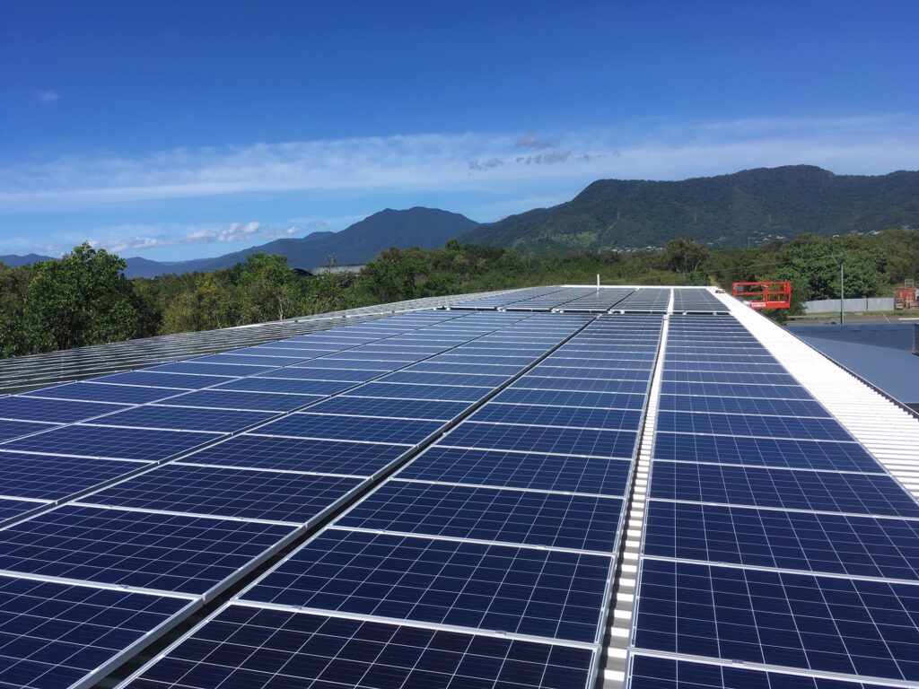 A view of the top of a building with solar panels on it.